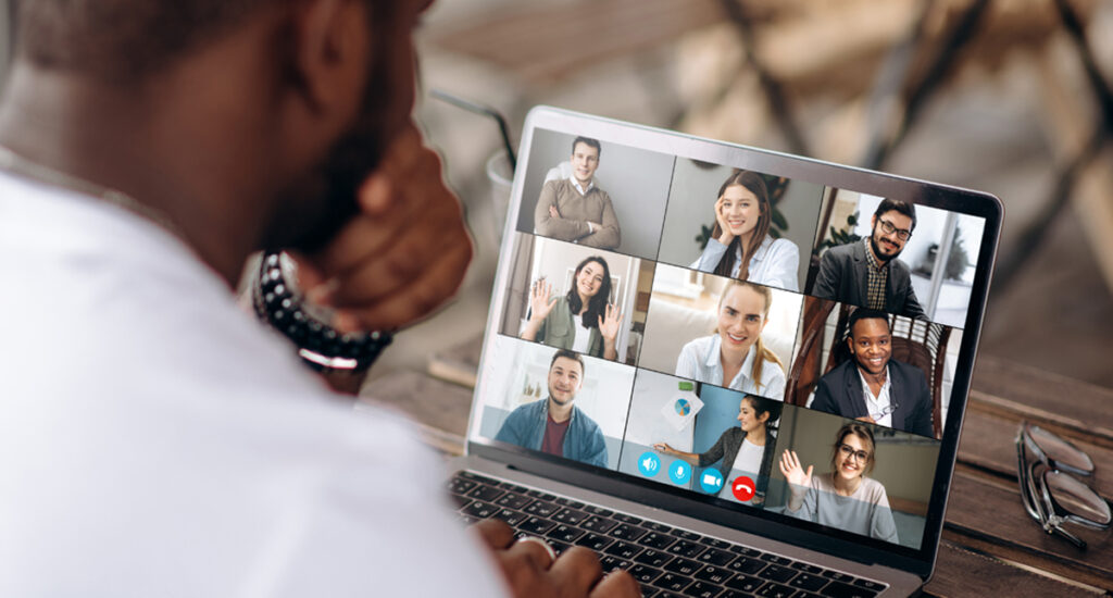 A photo of a man on a computer conference call.