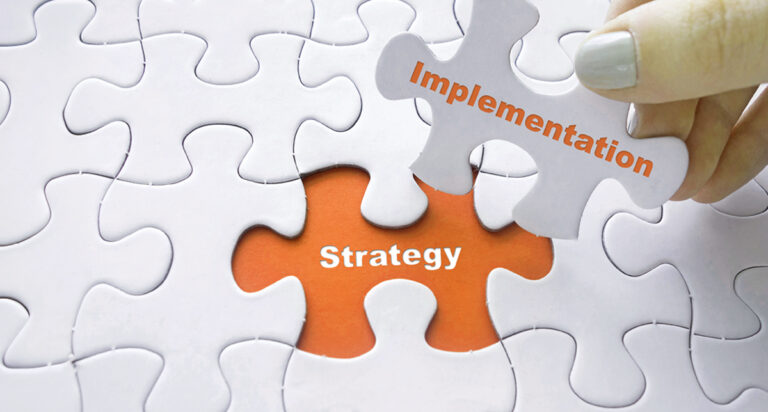 A graphic image of a jigsaw puzzle that shows the relationship between implementation and strategy.